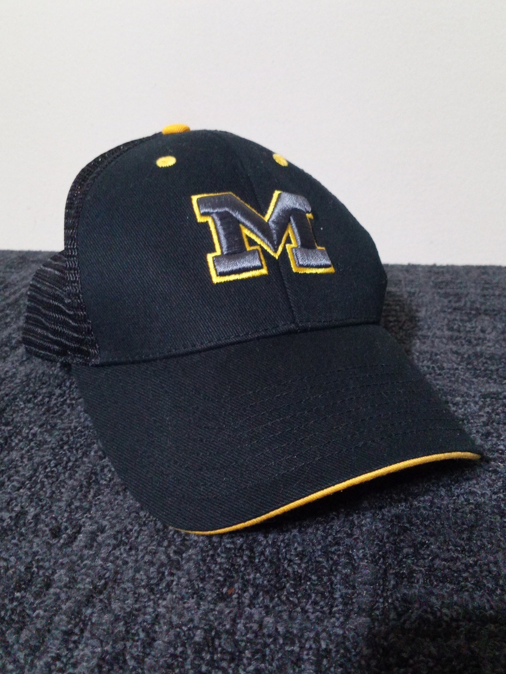 Black and Yellow 'M' Trucker Hat